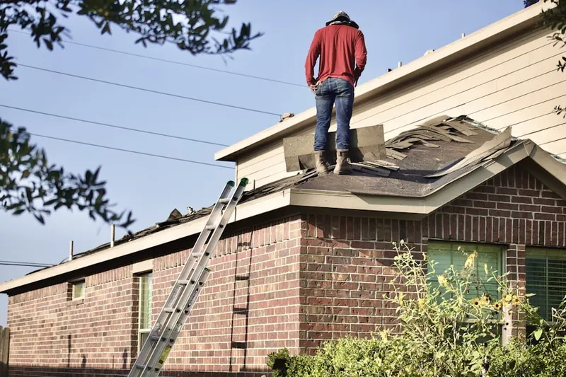 Professional roofer working on a residential roof in Chesterfield Square